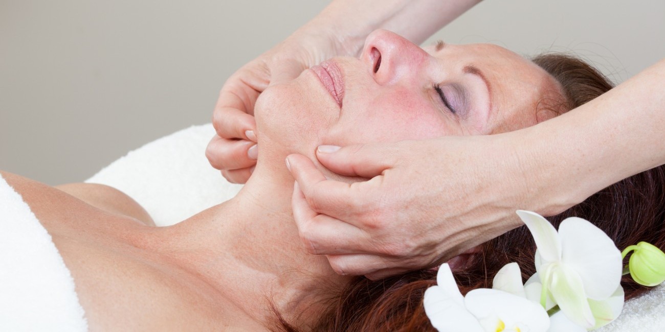 Mature Woman having relaxing head and face massage